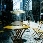 Empty Chairs And Tables At Cafe In City