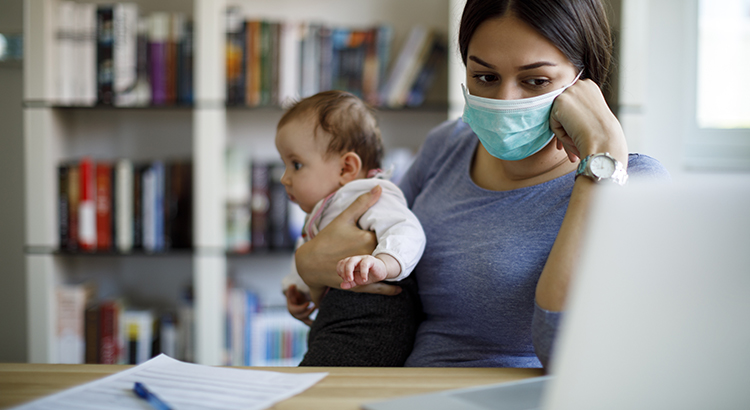 Worried mother with face protective mask working from home