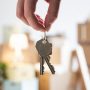 Close-up of woman holding house key in new home