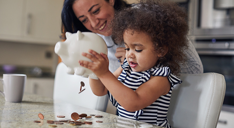 Mother and child getting money from a piggy bank